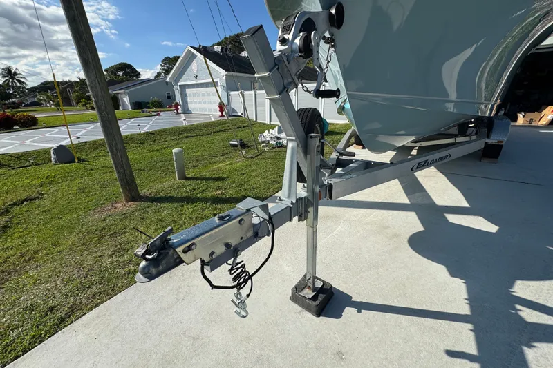 Slide: The Image of 2023 Sea Hunt Ultra 239 SE boat on trailer in residential driveway. - 19