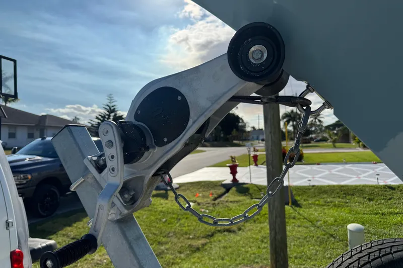 Slide: The Image of Trailer hitch of 2023 Sea Hunt Ultra 239 SE boat in a suburban setting. - 20