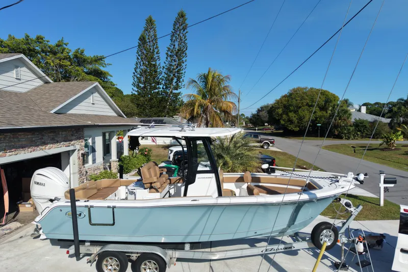 Slide: The Image of 2023 Sea Hunt Ultra 239 SE boat on trailer in residential driveway. - 22