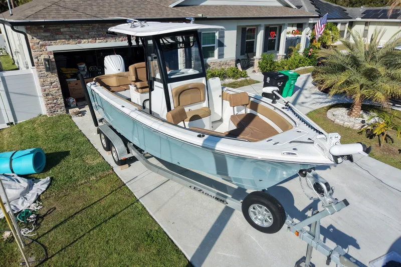 Slide: The Image of 2023 Sea Hunt Ultra 239 SE boat on trailer in residential driveway. - 4