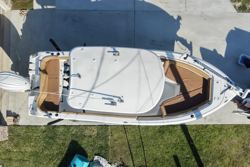 Slide: The Image of 2023 Sea Hunt Ultra 239 SE boat, aerial view, docked on concrete with brown seating. - 5