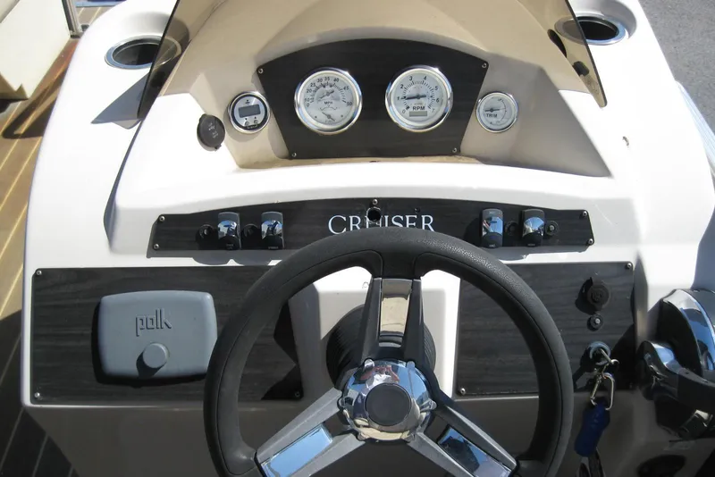Slide: The Image of Steering console of 2016 Harris FloteBote 200 Cruiser CX with gauges and controls. - 12