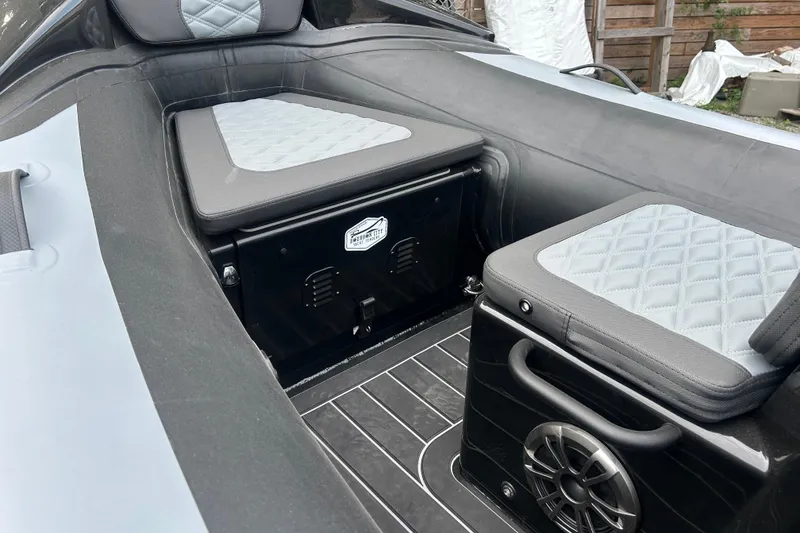 Slide: The Image of Interior of 2025 Highfield Sport 390 boat with cushioned seating and speaker system. - 10