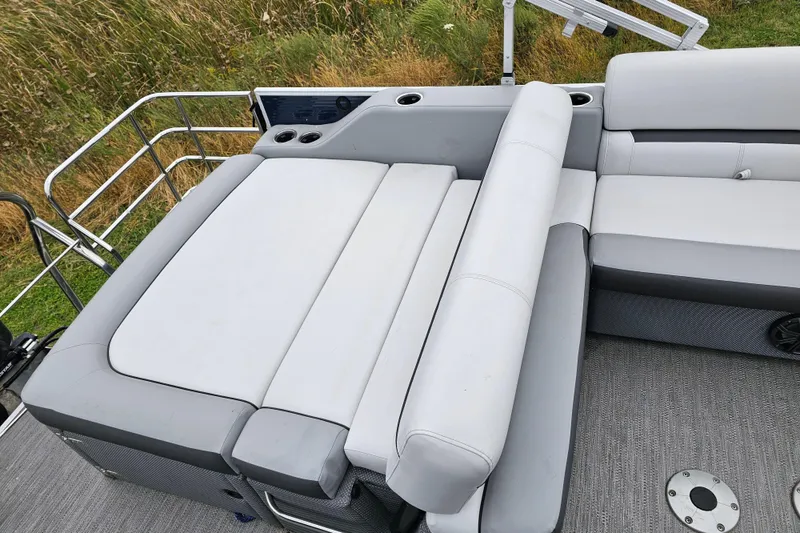 Slide: The Image of 2022 Sweetwater 2286 SFL boat interior with gray seating and cup holders. - 13