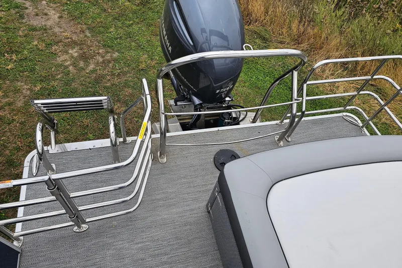 Slide: The Image of 2022 Sweetwater 2286 SFL boat deck with railing and outboard motor. - 14