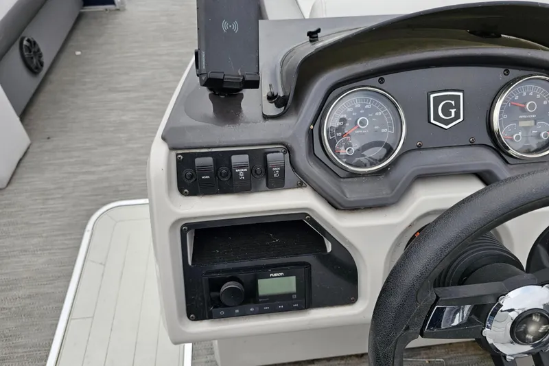 Slide: The Image of 2022 Sweetwater 2286 SFL boat dashboard with gauges and controls. - 9