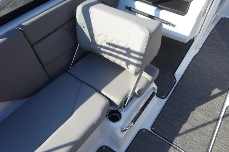 Slide: The Image of 2024 Four Winns H1 OB boat interior with gray seating and cup holder. - 10