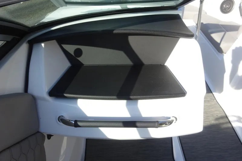 Slide: The Image of 2024 Four Winns H1 OB boat interior with black cushioned seating and sleek design. - 15