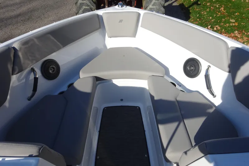 Slide: The Image of 2024 Four Winns H1 OB boat interior with gray seating and speakers. - 17
