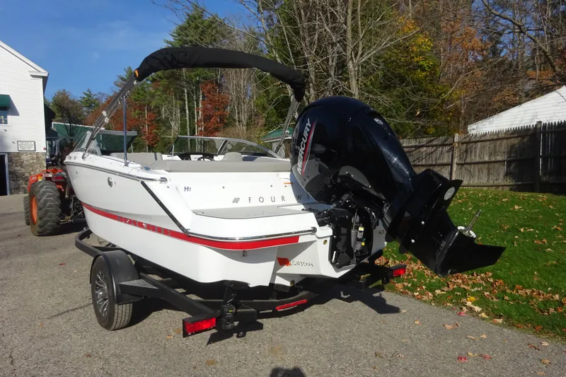 Slide: The Image of 2024 Four Winns H1 OB boat with Mercury outboard engine on trailer. - 3
