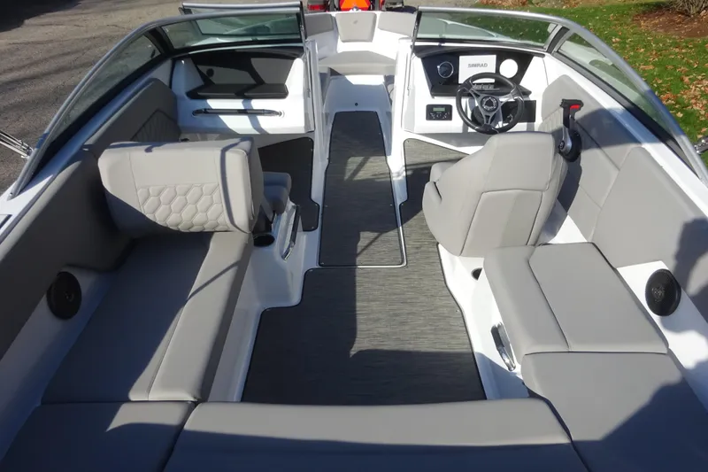 Slide: The Image of 2024 Four Winns H1 OB boat interior with modern seating and steering console. - 4