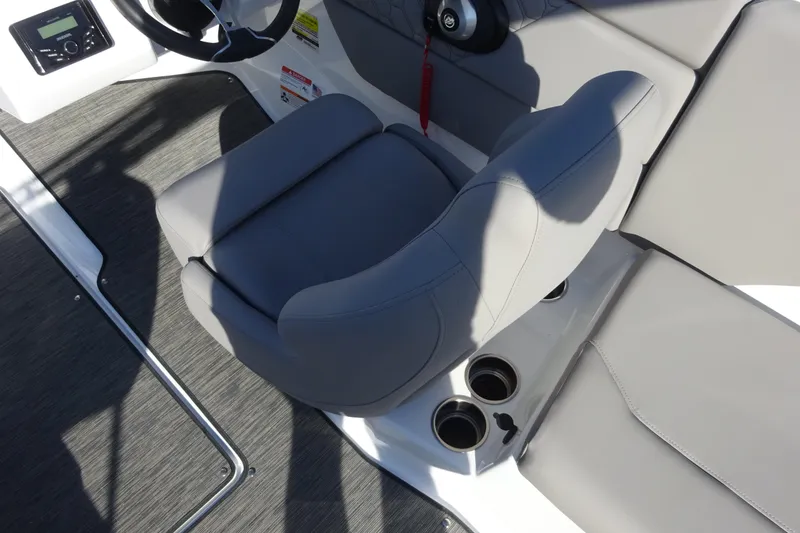 Slide: The Image of 2024 Four Winns H1 OB boat interior with gray seating and cup holders. - 5