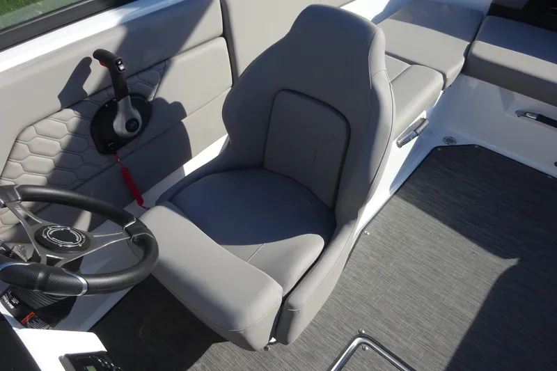 Slide: The Image of 2024 Four Winns H1 OB boat interior with gray seating and steering wheel. - 6