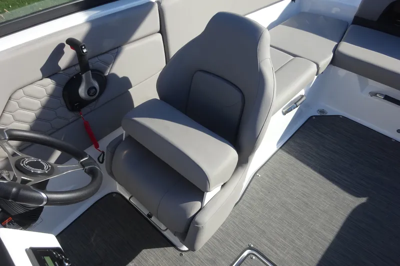 Slide: The Image of 2024 Four Winns H1 OB boat interior with gray seating and steering wheel. - 7
