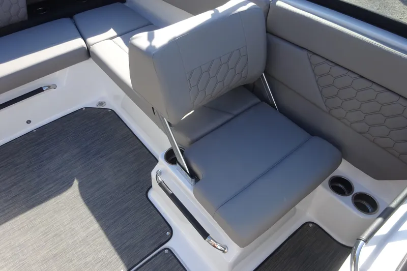 Slide: The Image of 2024 Four Winns H1 OB boat interior with gray seating and cup holders. - 9