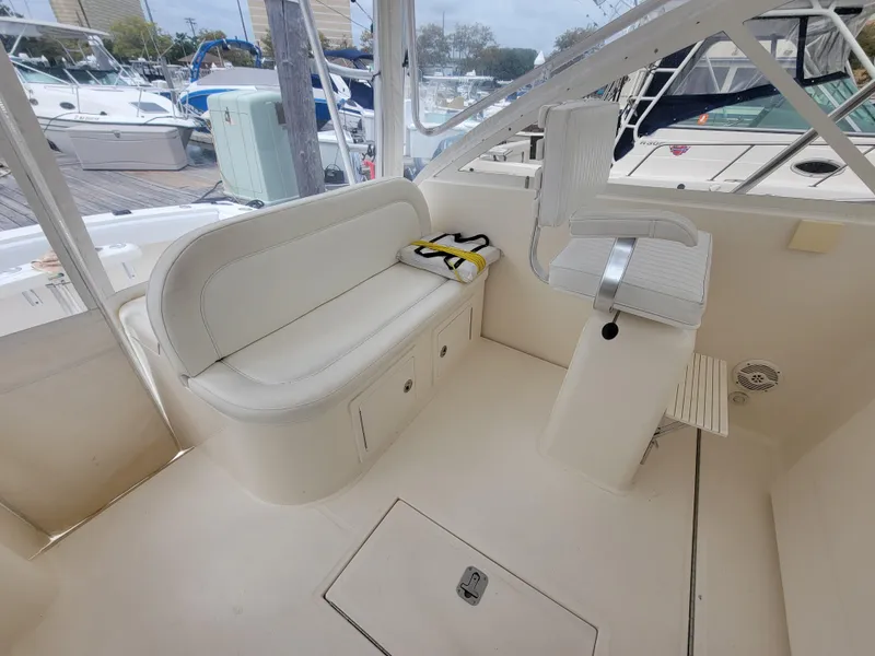 Slide: The Image of 2006 Carolina Classic 32 Express boat interior with seating and helm station. - 11