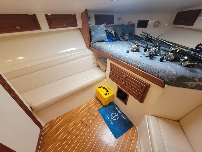 Slide: The Image of Interior of 2006 Carolina Classic 32 Express boat with fishing gear and seating. - 15