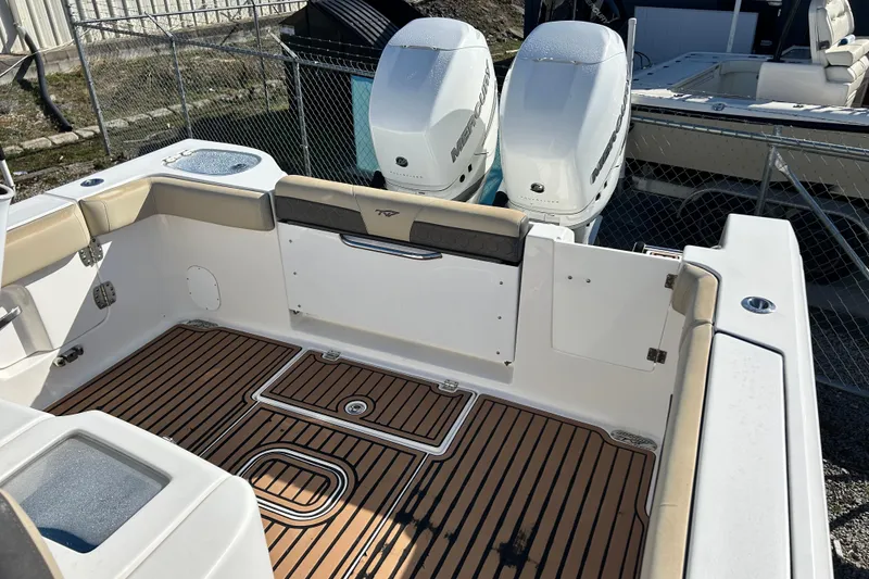 Slide: The Image of 2020 Tidewater 320 CC Adventure boat with twin outboard engines and teak flooring. - 13