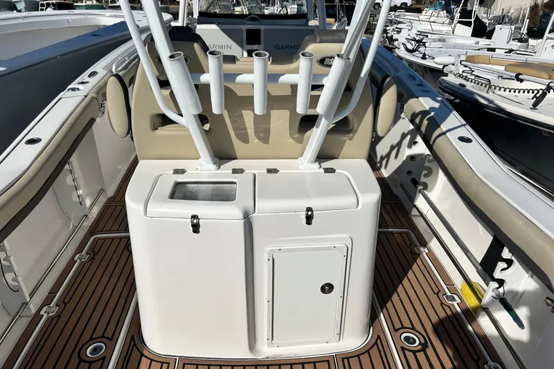 Slide: The Image of 2020 Tidewater 320 CC Adventure boat interior with rod holders and teak flooring. - 15