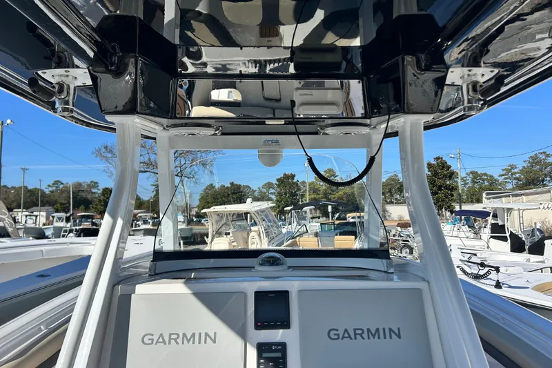 Slide: The Image of 2020 Tidewater 320 CC Adventure boat with Garmin navigation system, docked in a marina. - 19