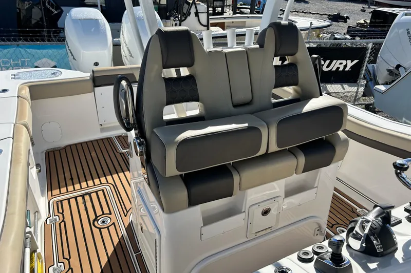 Slide: The Image of 2020 Tidewater 320 CC Adventure boat interior with dual seats and teak flooring. - 20
