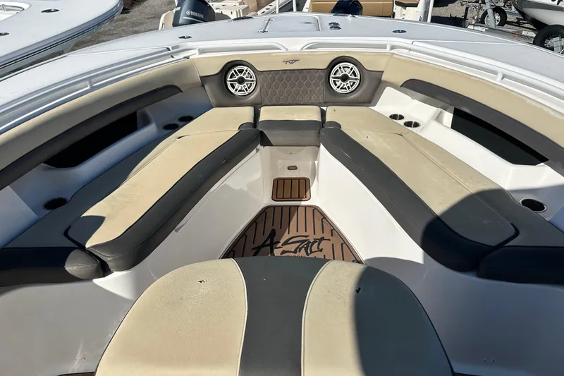 Slide: The Image of 2020 Tidewater 320 CC Adventure boat interior with cushioned seating and speakers. - 23