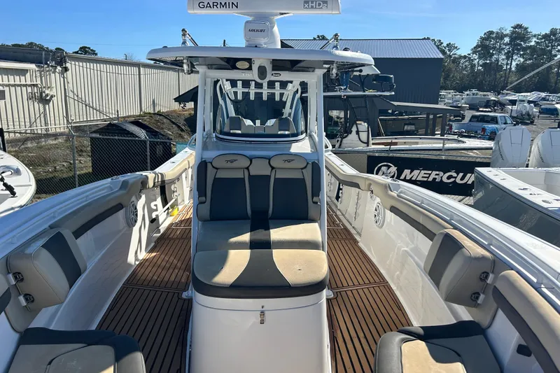 Slide: The Image of 2020 Tidewater 320 CC Adventure boat interior with seating and Garmin equipment. - 25