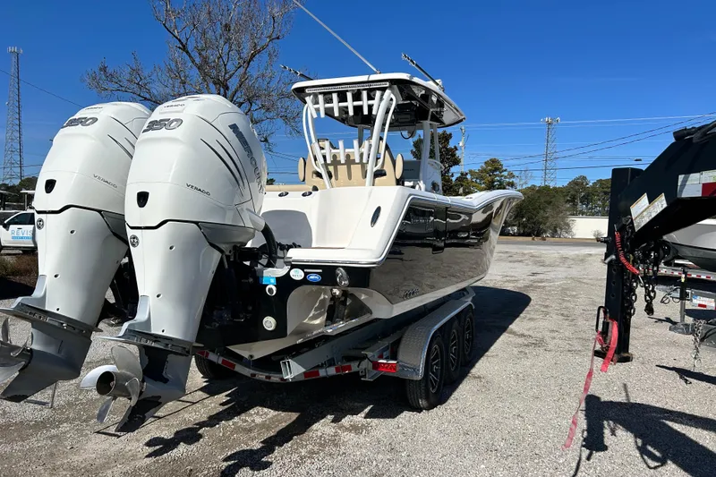 Slide: The Image of 2020 Tidewater 320 CC Adventure boat with dual Mercury engines on a trailer. - 7