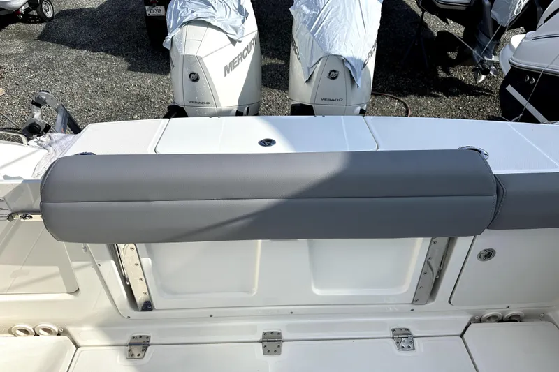 Slide: The Image of 2023 Boston Whaler OUTRAGE boat with Mercury Verado engines, featuring a cushioned seating area. - 11