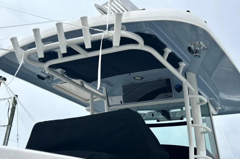 Slide: The Image of 2023 Boston Whaler OUTRAGE boat with sturdy T-top and rod holders. - 12