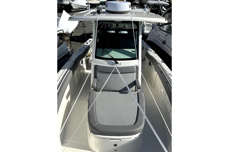 Slide: The Image of 2023 Boston Whaler OUTRAGE boat with sleek design and spacious seating. - 13