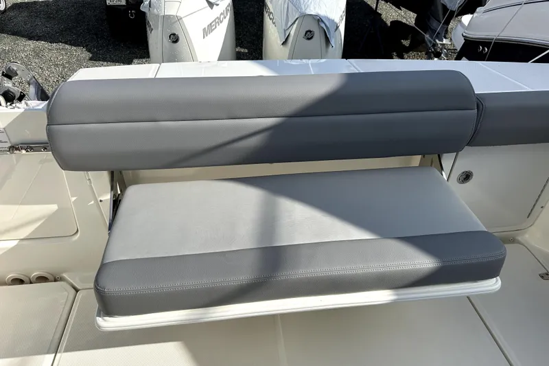 Slide: The Image of 2023 Boston Whaler OUTRAGE boat seat with gray upholstery and sleek design. - 19