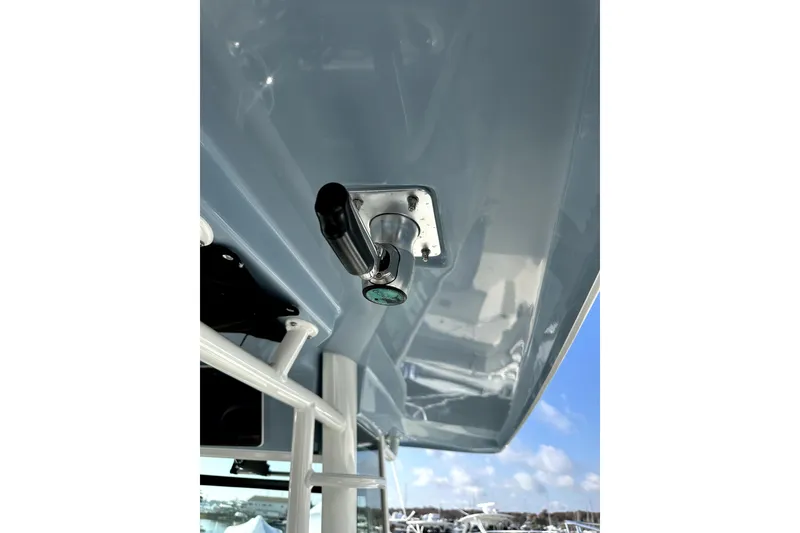 Slide: The Image of 2023 Boston Whaler OUTRAGE boat detail with stainless steel fitting under blue sky. - 2