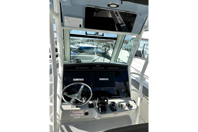 Slide: The Image of 2023 Boston Whaler OUTRAGE boat dashboard with Simrad navigation system. - 20