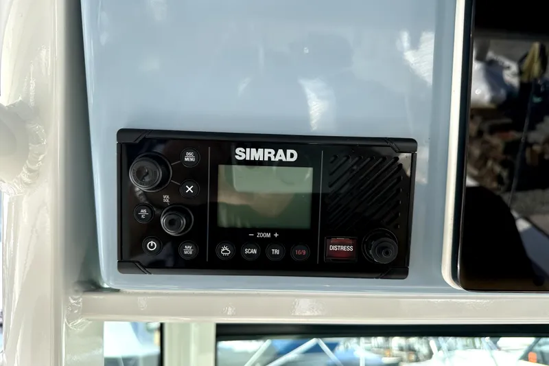 Slide: The Image of Simrad marine radio on 2023 Boston Whaler OUTRAGE boat dashboard. - 23