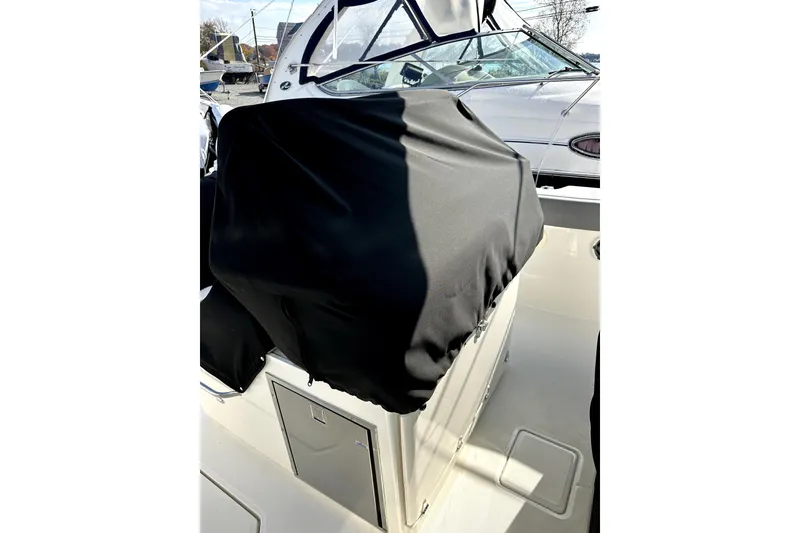 Slide: The Image of 2023 Boston Whaler OUTRAGE boat interior with covered console and windshield. - 4