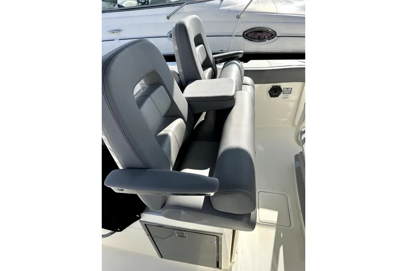 Slide: The Image of 2023 Boston Whaler OUTRAGE boat interior with gray seating and armrests. - 5