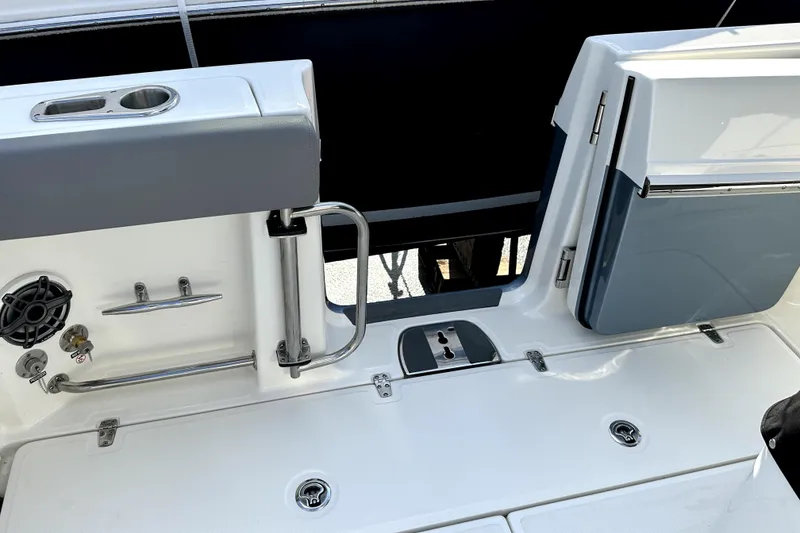 Slide: The Image of 2023 Boston Whaler OUTRAGE boat deck with storage and stainless steel fixtures. - 7