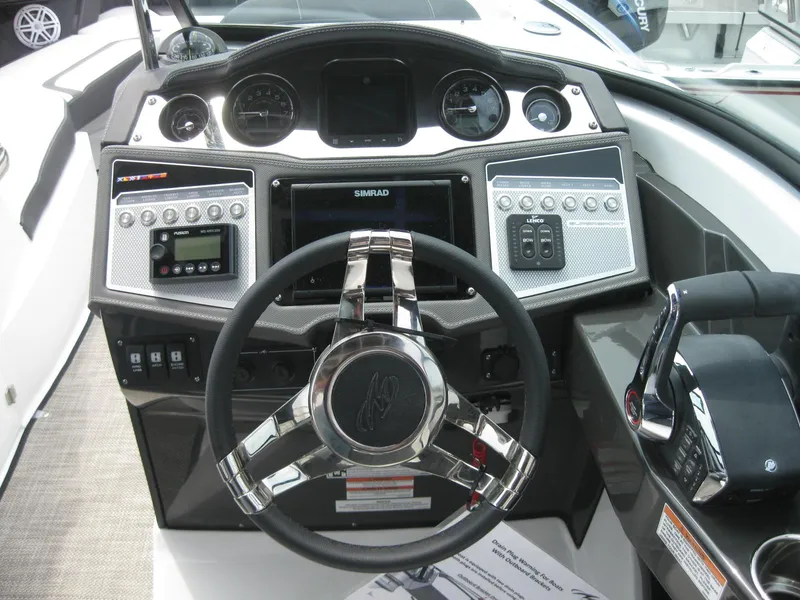 Slide: The Image of 2024 Monterey 305 SS boat dashboard with steering wheel and control panel. - 15