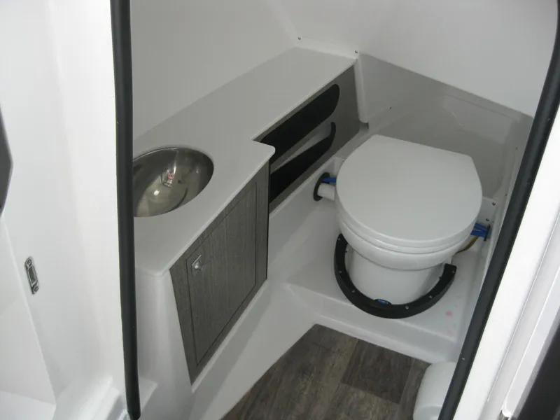 Slide: The Image of 2024 Monterey 305 SS boat bathroom with toilet and sink. - 19