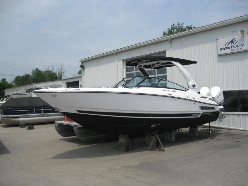 Slide: The Image of 2024 Monterey 305 SS boat displayed outside a dealership. - 2