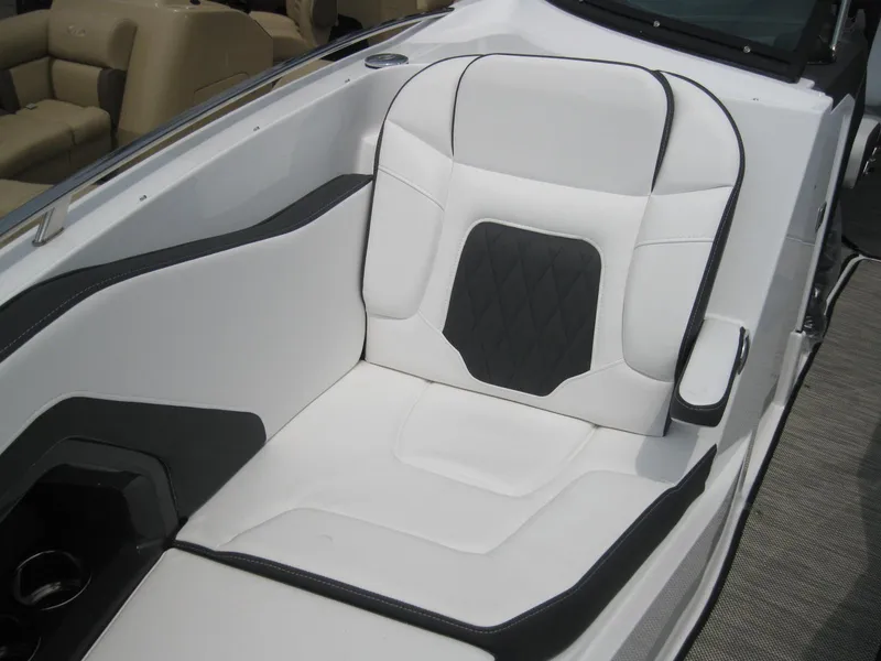 Slide: The Image of 2024 Monterey 305 SS boat interior with white and black cushioned seating. - 21