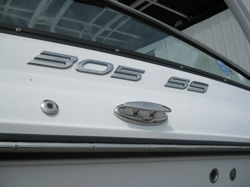 Slide: The Image of 2024 Monterey 305 SS boat exterior close-up with model name and chrome details. - 4