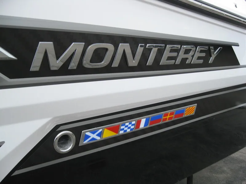 Slide: The Image of 2024 Monterey 305 SS boat with nautical flags. - 5