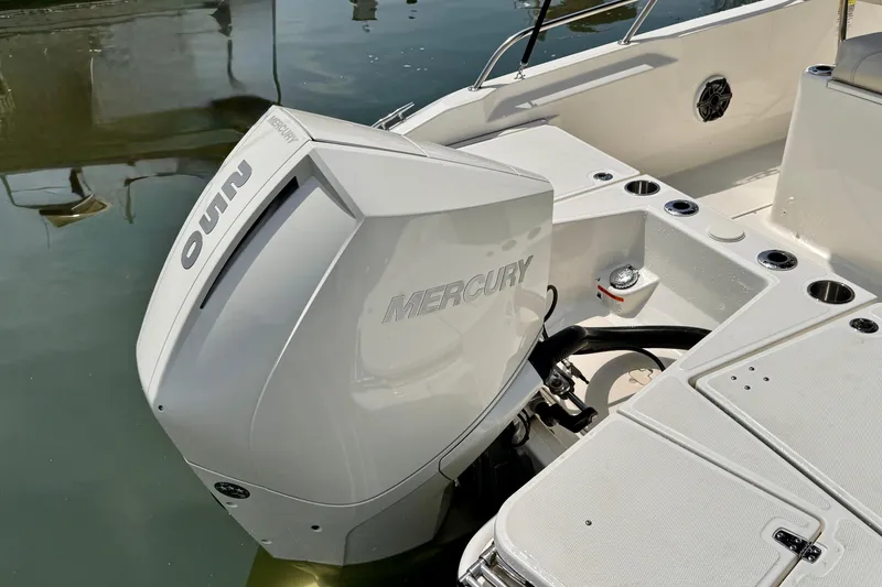 Slide: The Image of 2022 Boston Whaler 220 Dauntless with Mercury outboard engine on calm water. - 10