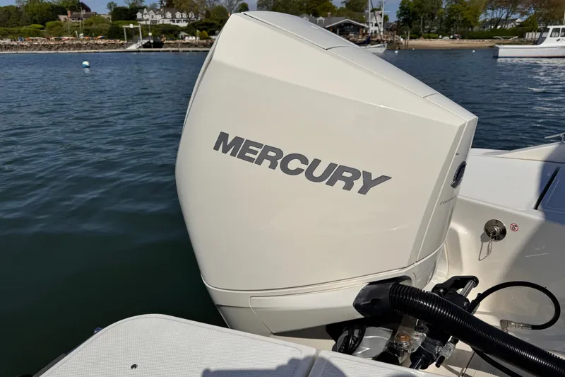 Slide: The Image of 2022 Boston Whaler 220 Dauntless with Mercury outboard engine on calm water. - 11