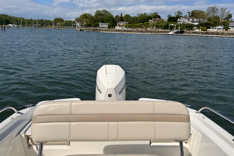 Slide: The Image of 2022 Boston Whaler 220 Dauntless boat on water, scenic shoreline view. - 12