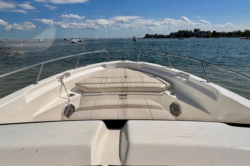 Slide: The Image of 2022 Boston Whaler 220 Dauntless boat on calm water, sunny day, clear sky. - 6