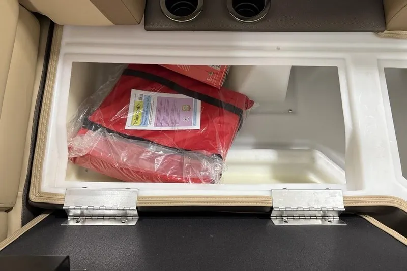 Slide: The Image of Storage compartment in 2026 Godfrey Monaco 235 SFL boat with red life jacket. - 10