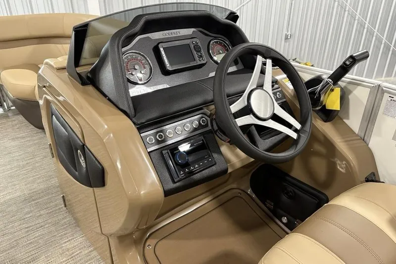 Slide: The Image of 2026 Godfrey Monaco 235 SFL boat dashboard with steering wheel and control panel. - 17